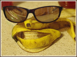Arrangement of banana peels and eyeglasses as an imaginary human face.